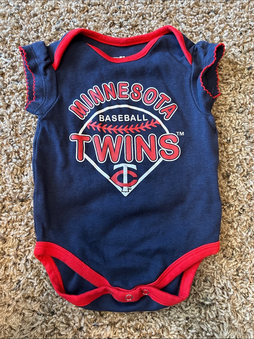 Genuine Merchandise Navy Onesie with Red Trim